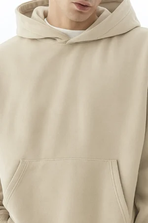 A person who wear beige color hoodie chest view